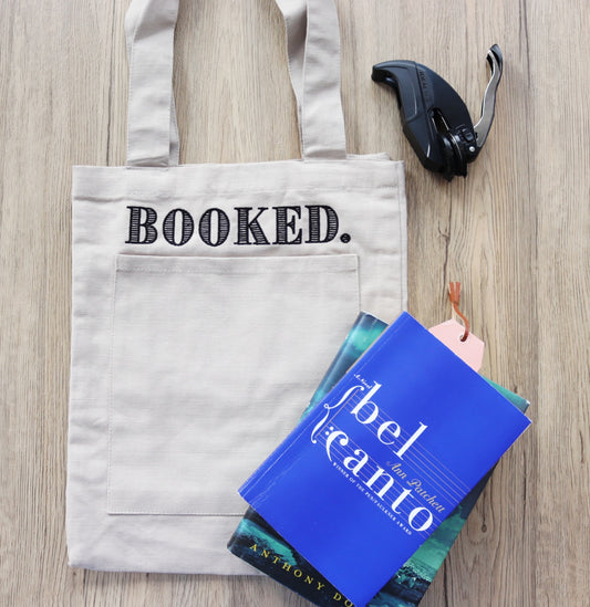 “Booked.” Canvas Tote Bag
