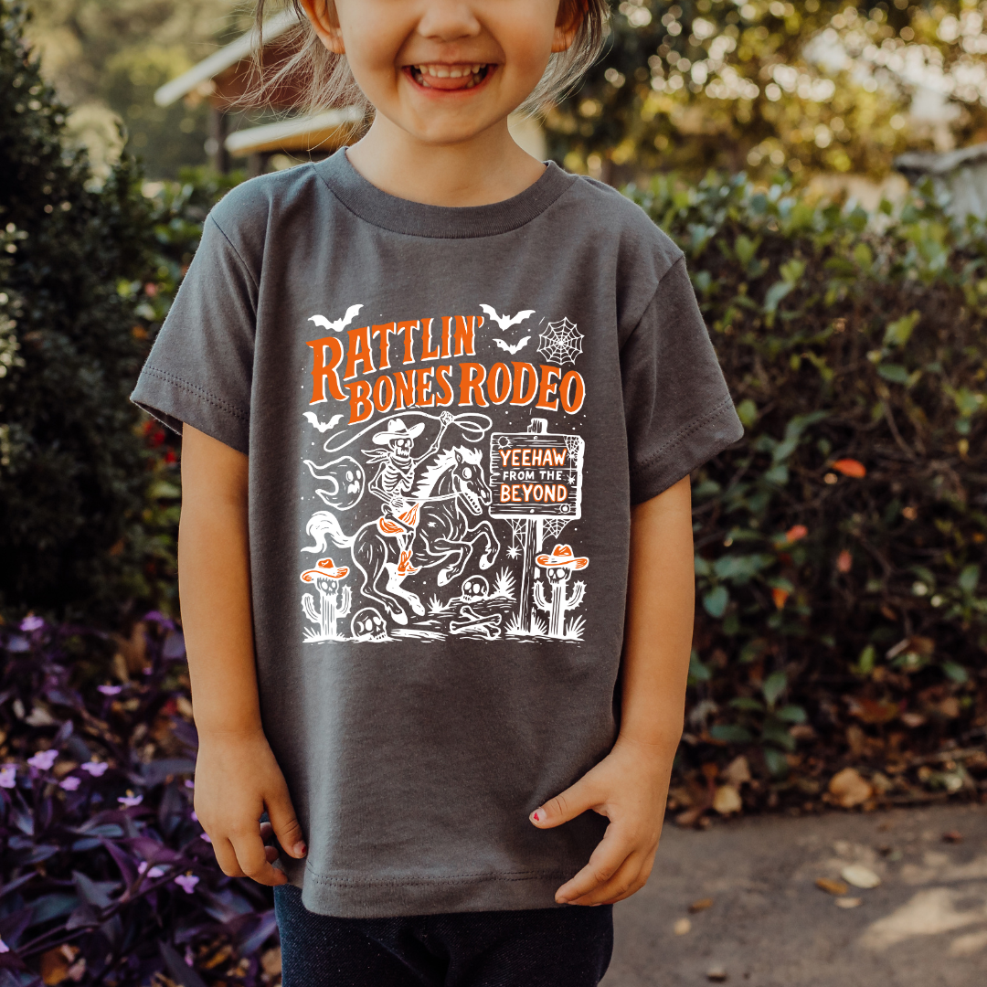 Rattlin’ Bones Rodeo Toddler Tee | Skeleton Cowboy Halloween Shirt 🐎💀 Toddler T Shirt